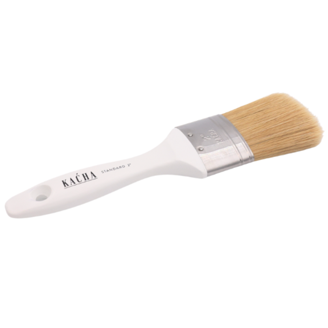 Paint brush with white handle and wooden bristles on a white background