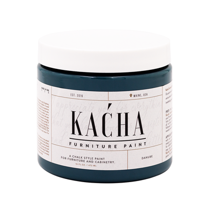 Jar of K£ňha furniture paint on a white background